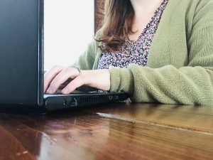 writer typing on her computer