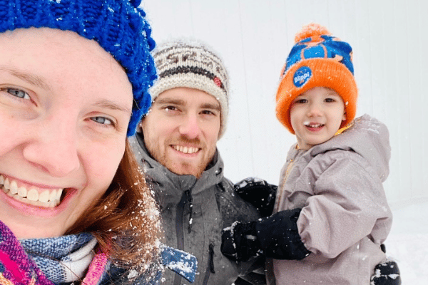 Family outside in winter jackets smiling