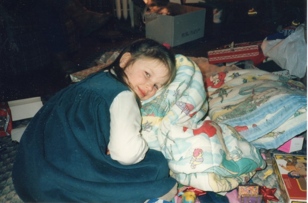 Young girl in a dress, smiling at the camera