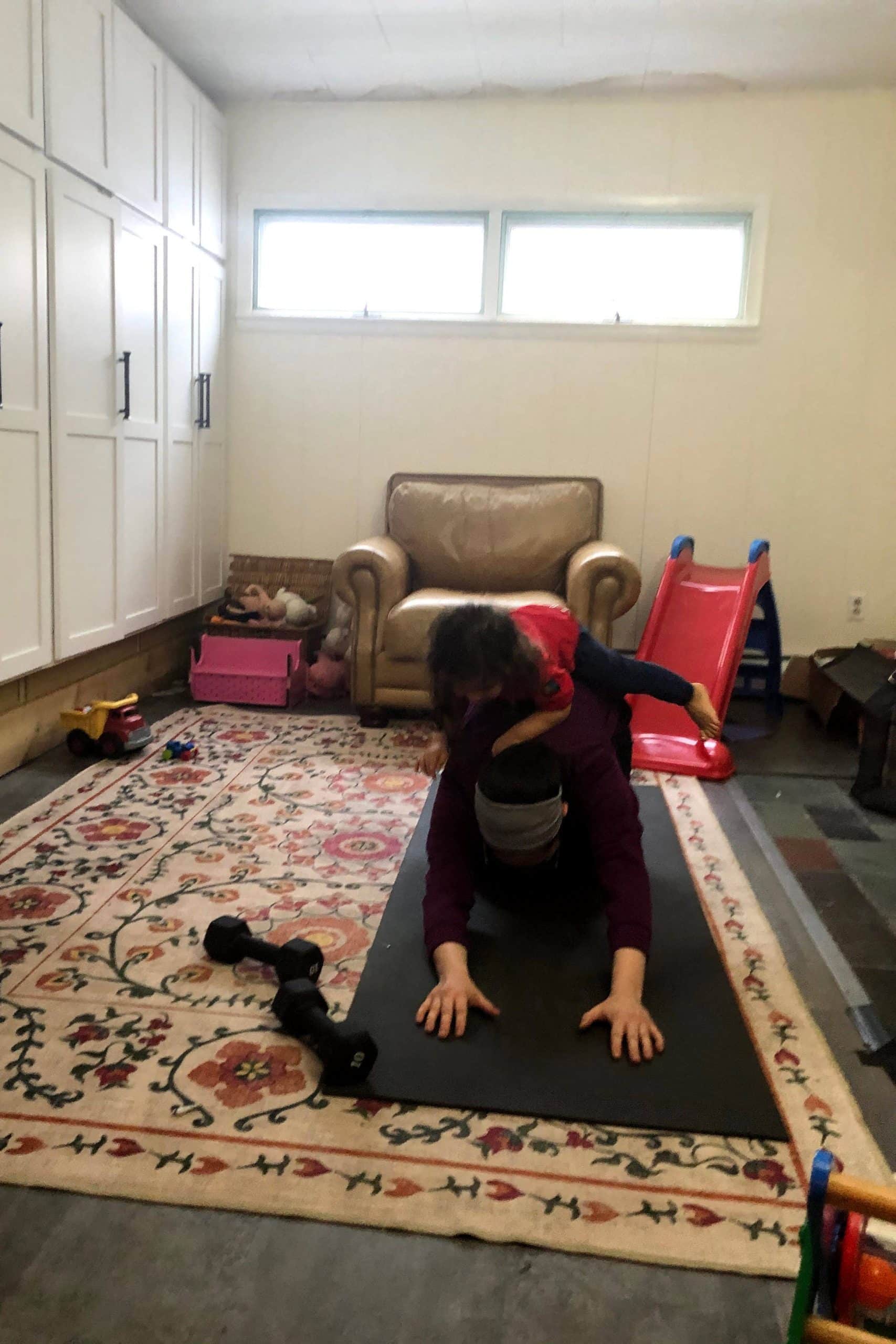 Mom Exercising After Giving Birth Mom with 2 year old jumping on her back while trying to work out