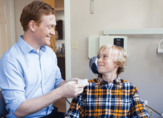 Advanced Dentistry of Vermont Gave this Mom a New Reason to Smile dentist smiles at teen patient