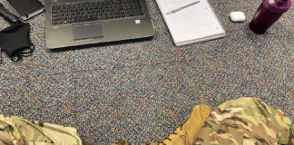 Parenting Roles: What Happens When Mom Leaves For Eight Weeks? legs shown in fatigues and boots in front of a laptop, on the floor