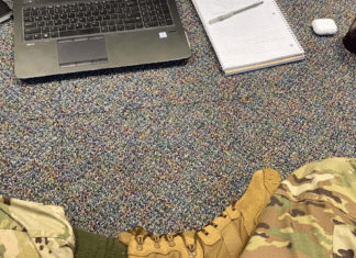 Parenting Roles: What Happens When Mom Leaves For Eight Weeks? legs shown in fatigues and boots in front of a laptop, on the floor