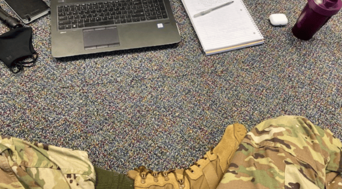 Parenting Roles: What Happens When Mom Leaves For Eight Weeks? legs shown in fatigues and boots in front of a laptop, on the floor