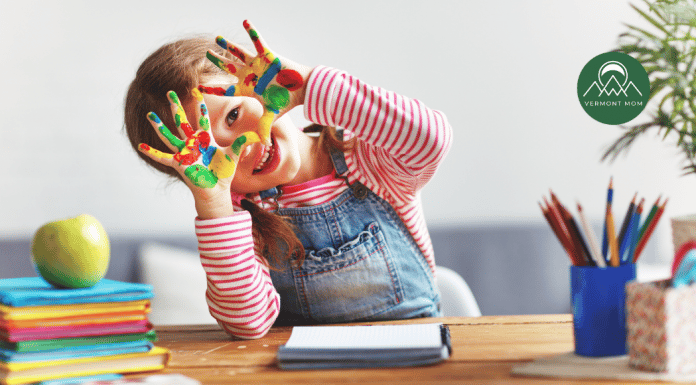 Vermont Guide to Preschools in Burlington and Beyond Preschool-aged girl smiling with paint on her hands