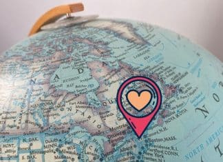 Why This Mom Loves Vermont The northwestern hemisphere of a globe, with a locational pin and a heart over Vermont.