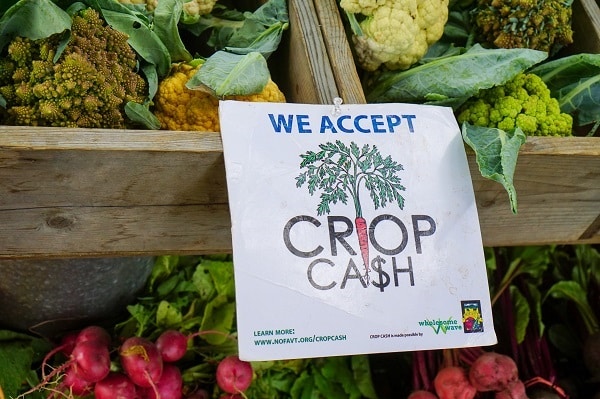Coupons allow lower income people to purchase fresh food at farmers markets.