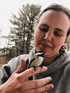 woman holding a chickadee