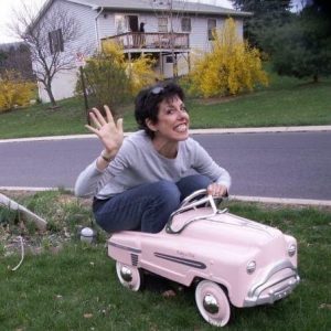 Woman in a child's toy electric car