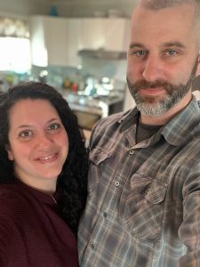 A couple takes a selfie in their kitchen