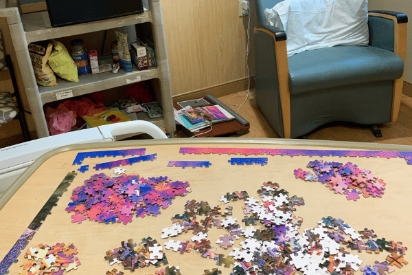jigsaw puzzle on a table in a hospital room.