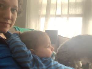 woman holding a toddler on her lap on the sofa