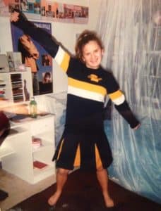 preteen girl in a cheerleading outfit