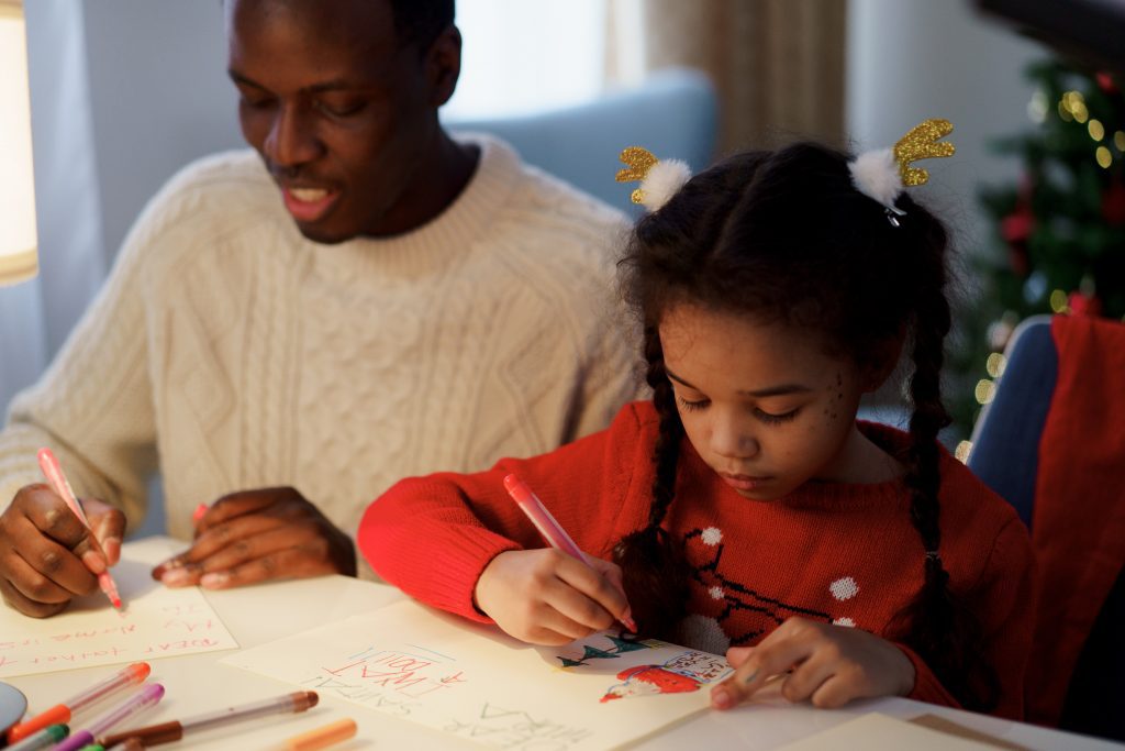 Father and daughter drawing and writing together
