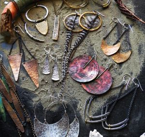 jewelry laid out on a sandy surface