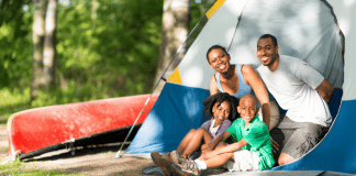 Camping With Young Children and Actually Enjoying It family camping- looking out from the doorway of their tent