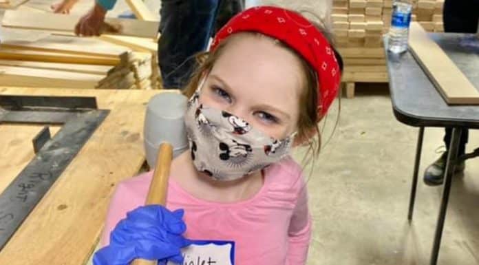 How and Why I Started Volunteering with My Child young girl doing volunteer work with a mallet