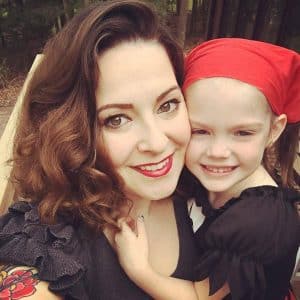 Woman wearing red lipstick with child