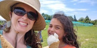 Vermont Summer Bucket List: Find Your Green Mountain Adventure A woman and a girl smile in an open field, holding ice cream cones