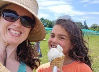 Vermont Summer Bucket List: Find Your Green Mountain Adventure A woman and a girl smile in an open field, holding ice cream cones