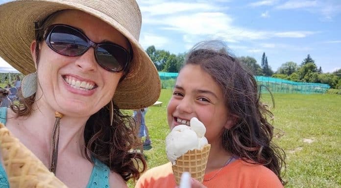 Vermont Summer Bucket List: Find Your Green Mountain Adventure A woman and a girl smile in an open field, holding ice cream cones