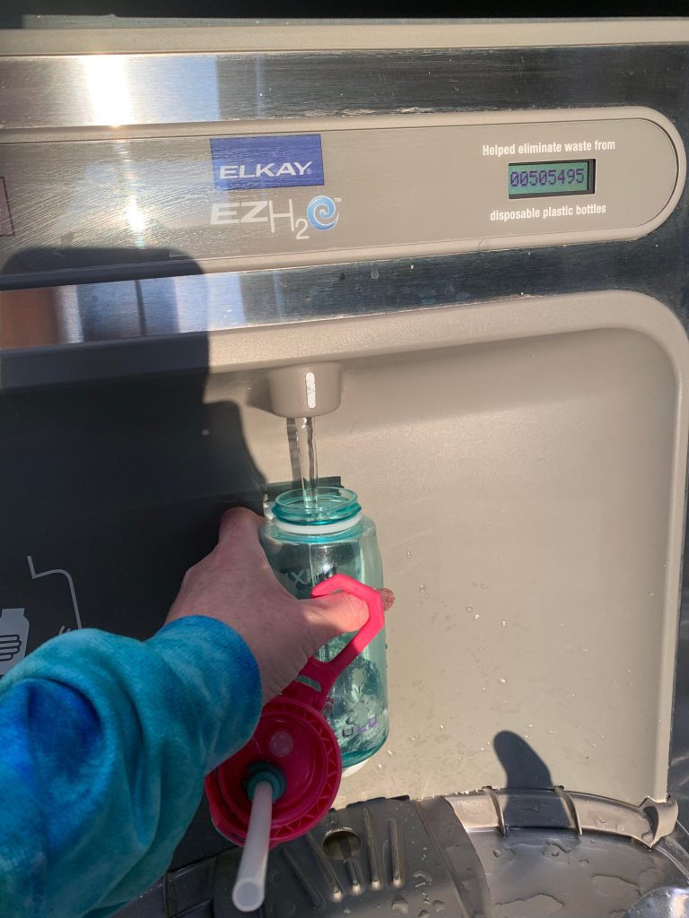 filling up a water bottle at the airport