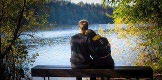 Weekend Afternoon Date Ideas in Chittenden County Couple looking out at a lake together.