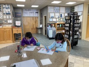 Toddlers hard at work at the a tile showroom