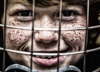 Concussions in Kids- Signs and Symptoms child wearing a helmet
