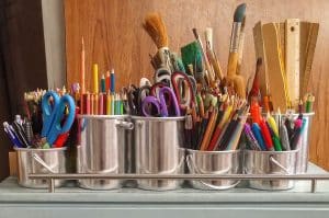 School supplies displayed neatly in metal containers.