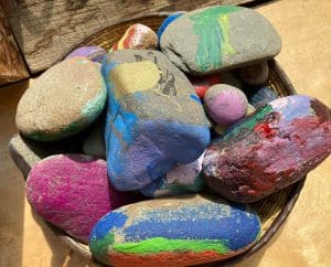 Basket full of painted rock paperweights