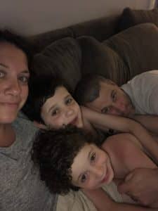 family snuggling while watching TV together