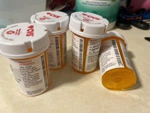 four prescription pill bottles