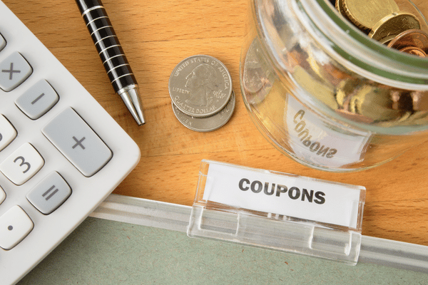 change, a pen, and a label that says "coupons" on it