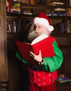 Santa looking in a big, red book