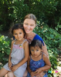 Mother and two daughters posing for a photo together