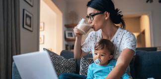 How I am Taking My Power Back Through Self-Care mom drinks coffee while holding her baby