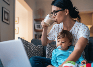How I am Taking My Power Back Through Self-Care mom drinks coffee while holding her baby