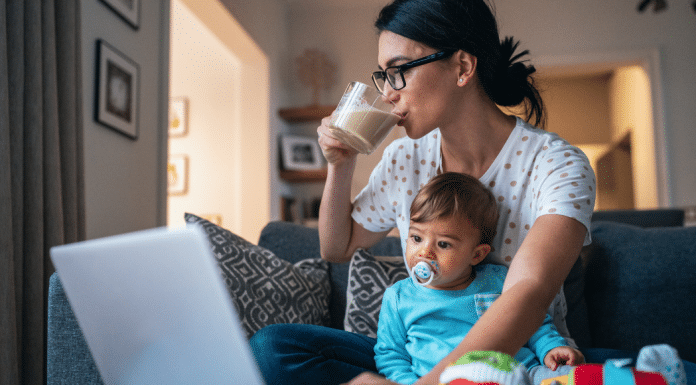 How I am Taking My Power Back Through Self-Care mom drinks coffee while holding her baby