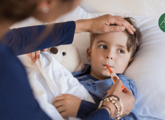 When Does Fever in Children Require Medicine? A Doctor’s Advice mother taking the temperature of a young boy with a fever