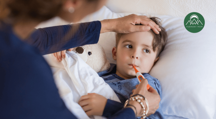 When Does Fever in Children Require Medicine? A Doctor’s Advice mother taking the temperature of a young boy with a fever