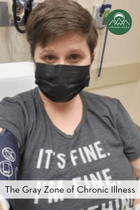 woman sitting on a hospital bed wearing a mask