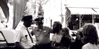 Police Brutality, the Fall of Roe, and Why I Take a Knee man holding a little girl while speaking to police officers during an arrest