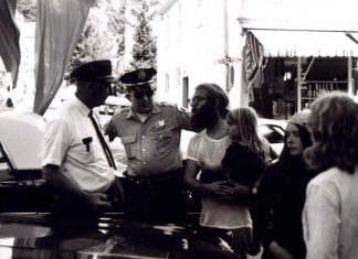 Police Brutality, the Fall of Roe, and Why I Take a Knee man holding a little girl while speaking to police officers during an arrest