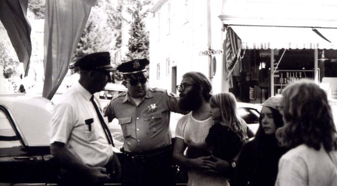 Police Brutality, the Fall of Roe, and Why I Take a Knee man holding a little girl while speaking to police officers during an arrest