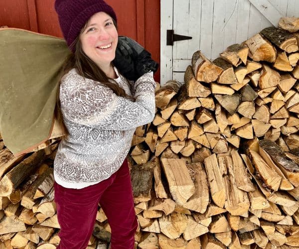 Woman standing in front of a large pile of firewood: parenting as an introvert
