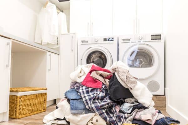 A laundry room with a pile of clothes