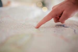 finger pointing to road map