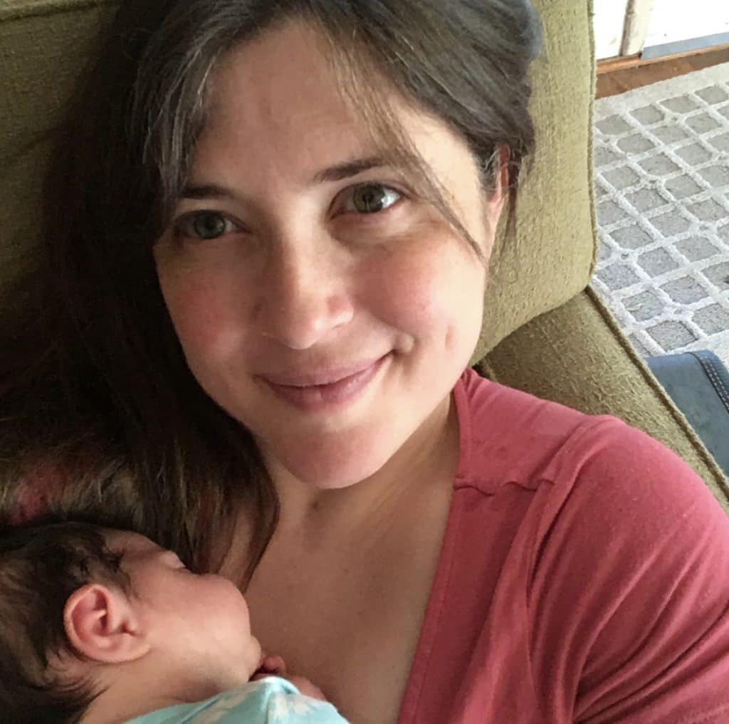mom life after 40: a mom holding a newborn