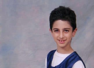 I Was Bullied: Lessons from the Bottom of the Social Hierarchy 7 year old girl with short hair wearing basketball uniform and holding a basketball kneels for a photo. She began to bullied a lot around this time.